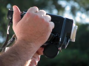 help us make videos man holding video camera